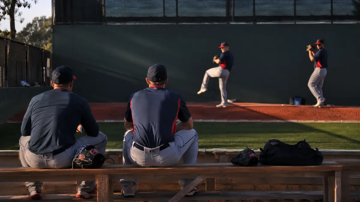 Two baseball pitchers warming up in the bullpen